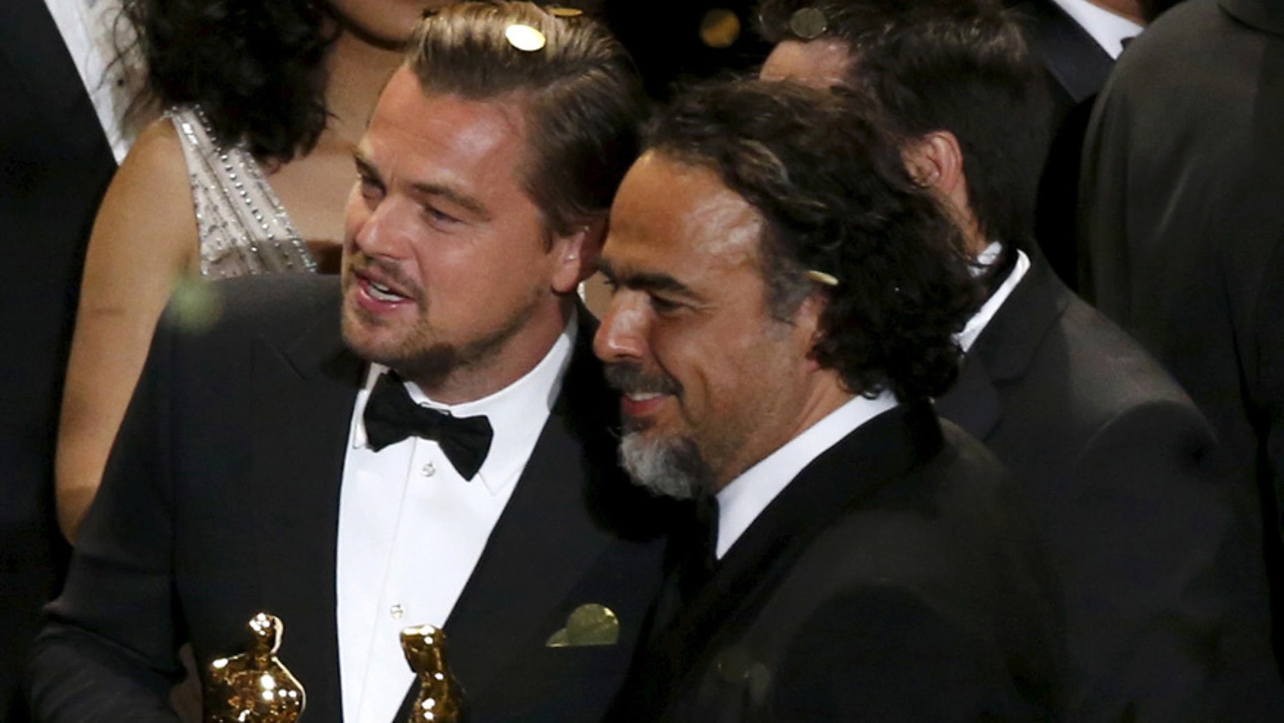 Director Alejandro Inarritu (R) and actor Leonardo DiCaprio hold their Oscars after the end of the awards ceremony at the 88th Academy Awards in Hollywood, California February 28, 2016. REUTERS/Mario Anzuoni TPX IMAGES OF THE DAY - RTS8HAU