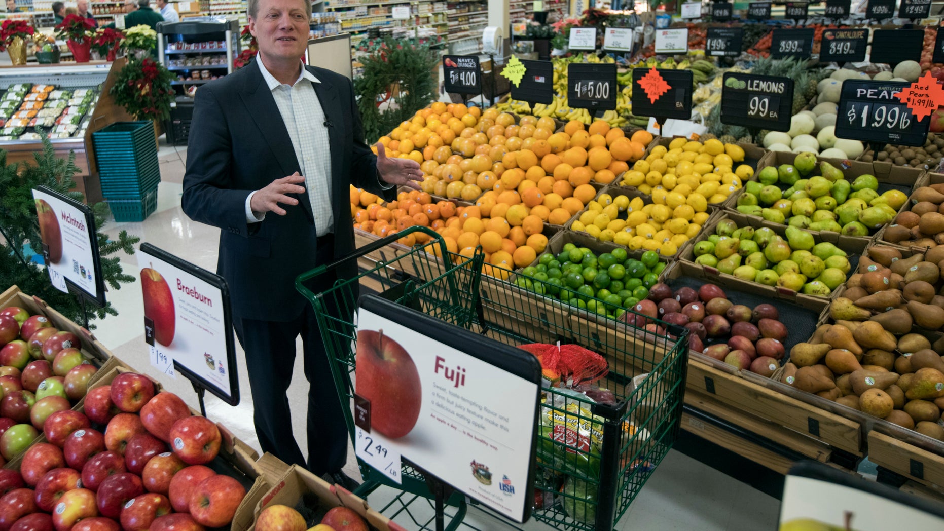 In this Tuesday, Dec. 6, 2016 photo, Brian Wansink, a food behavior scientist at Cornell University, speaks during an interview in the produce section at a supermarket in Ithaca, N.Y. In a study of 1,200 shoppers, every minute spent in the produce section meant $1.80 more in fruit and vegetable sales. (AP Photo/Mike Groll)