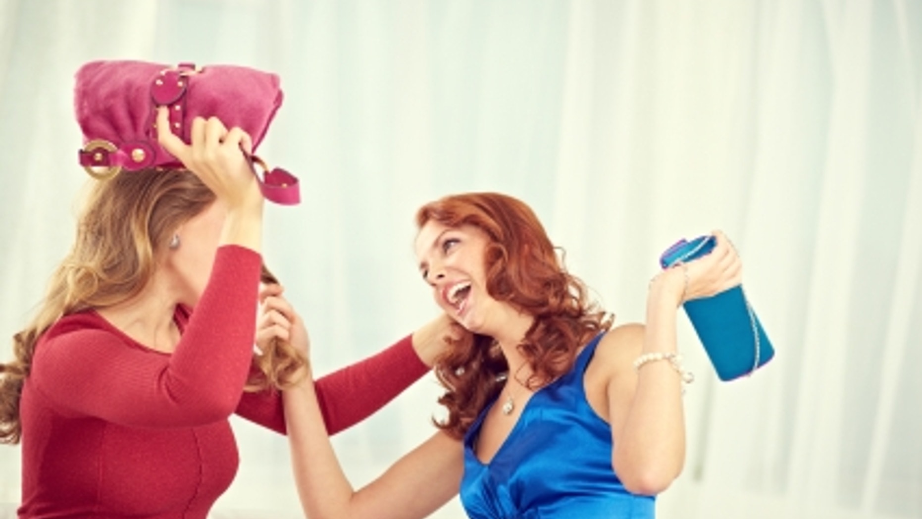 Two pretty young women fighting furiously