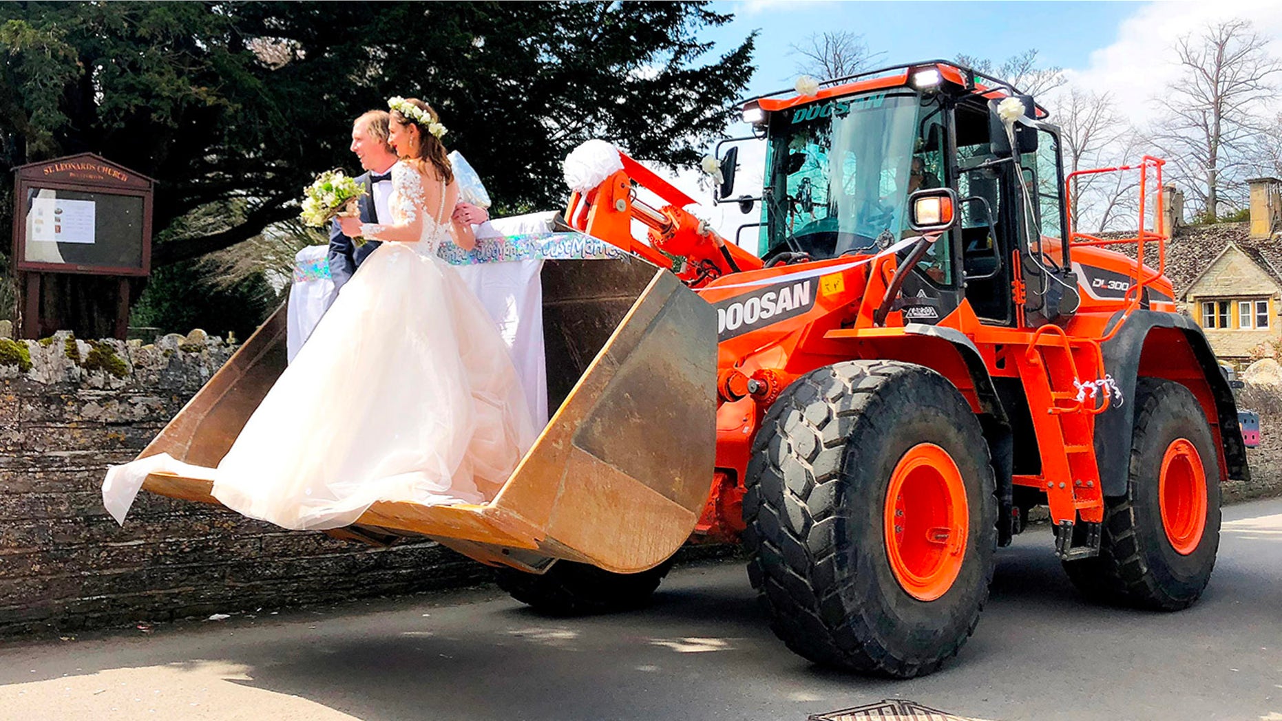A JCB driver and his new bride stunned guests when they turned up to their wedding reception â in the bucket of a giant DIGGER. See NTI story NTIWED. Jason Smith, 29, and his bride Iona, 28, ditched the traditional horse-drawn carriage and opted instead for an 18 ton earth mover. They arrived at their wedding at Bretforton Church, Evesham, Worcs., on Saturday (5/4) in the digger in front of friends and family. Jasonâs colleagues at local firm Budget Skips organised the transport as a surprise for him and new wife Iona.