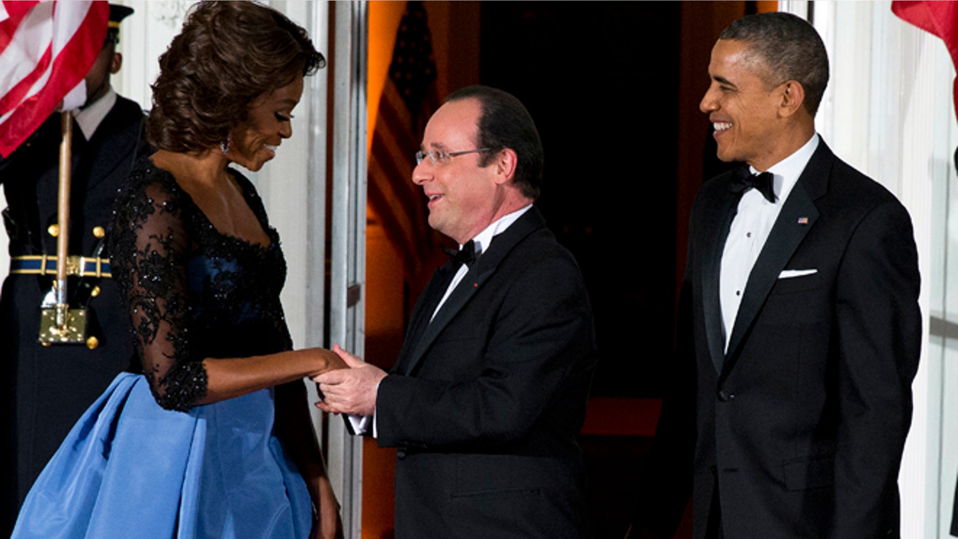 Feb. 11, 2014: First lady Michelle Obama, left, and President Barack Obama welcome French President François Hollande for a State Dinner at the North Portico of the White House in Washington.
