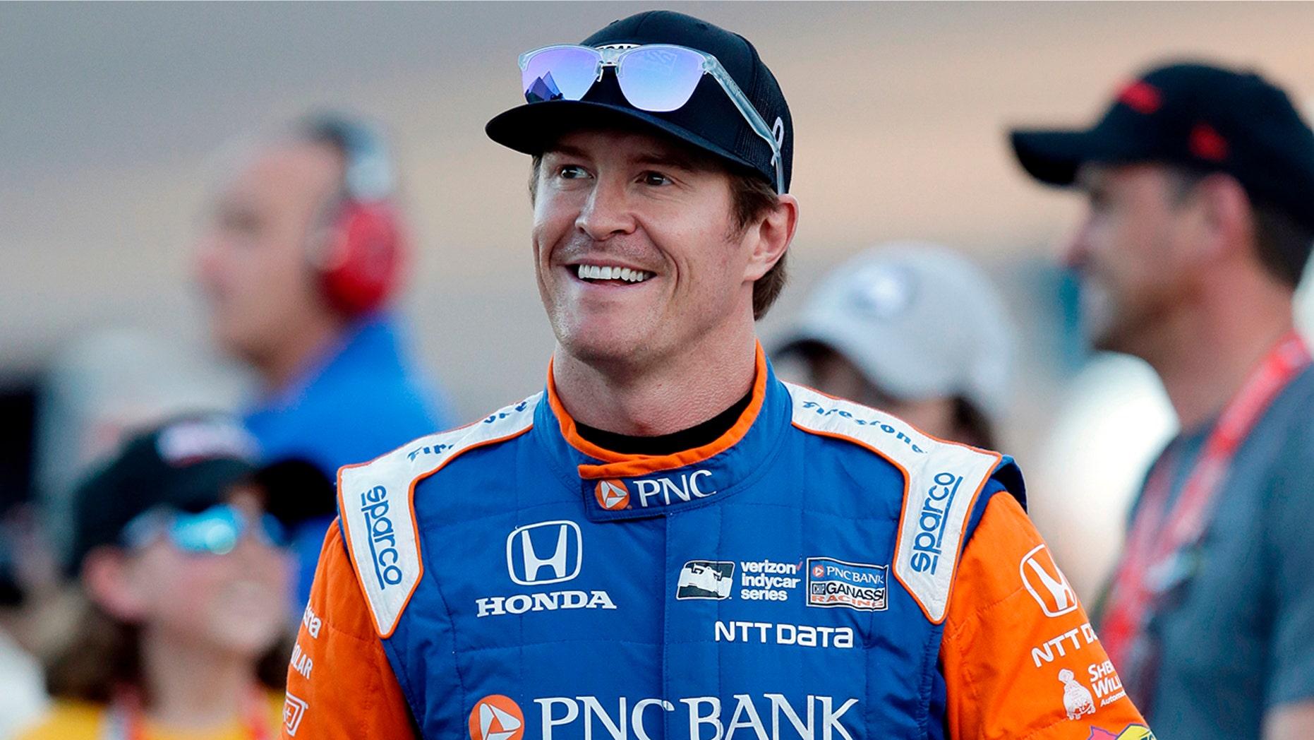 FILE - In this Saturday, April 7, 2018, file photo, driver Scott Dixon smiles before the IndyCar auto race at Phoenix International Raceway in Avondale, Ariz. Dixon will be the latest IndyCar driver to enter the realm of reality TV when he auditions in Indianapolis next week for "American Ninja Warrior. (AP Photo/Rick Scuteri, File)
