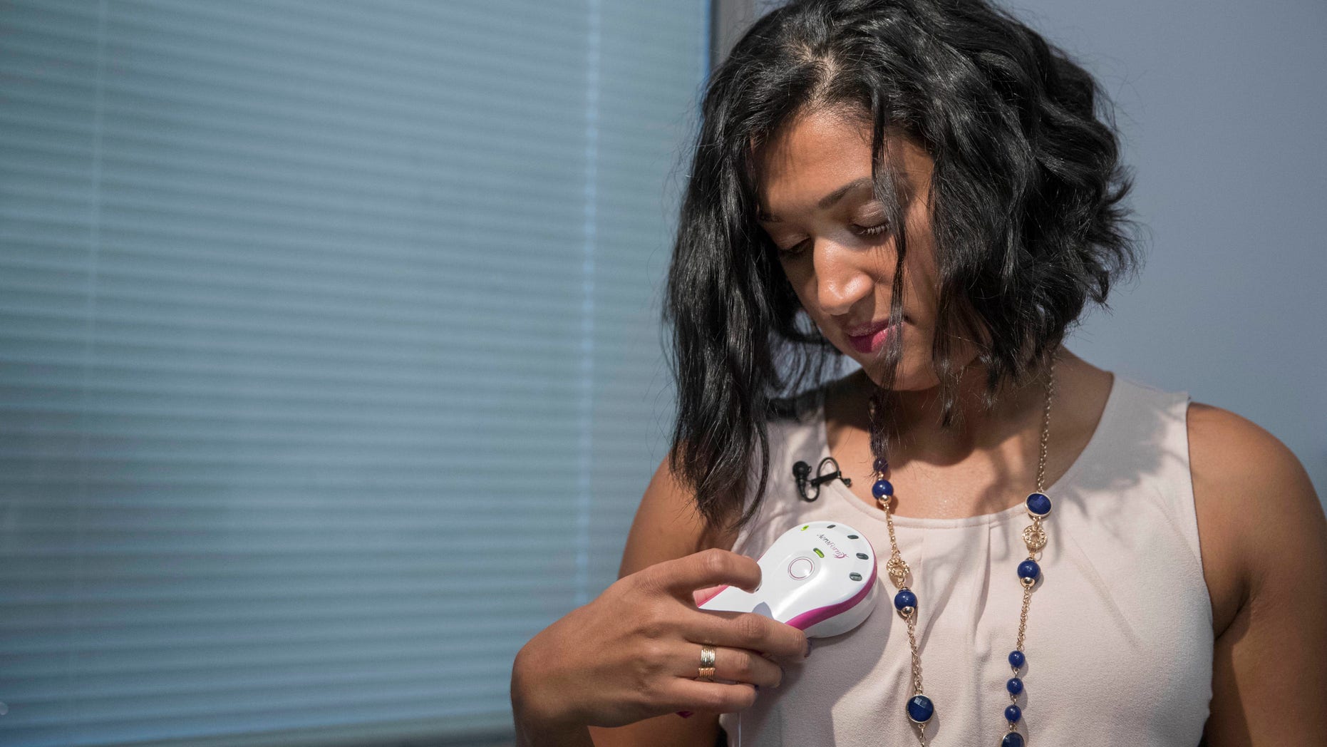 In this Thursday, Oct. 20, 2016, photo, Luincys Fernandez demonstrates how she had used the AeroForm handheld dosage controller during an interview at NewYork-Presbyterian/Columbia University Medical Center.