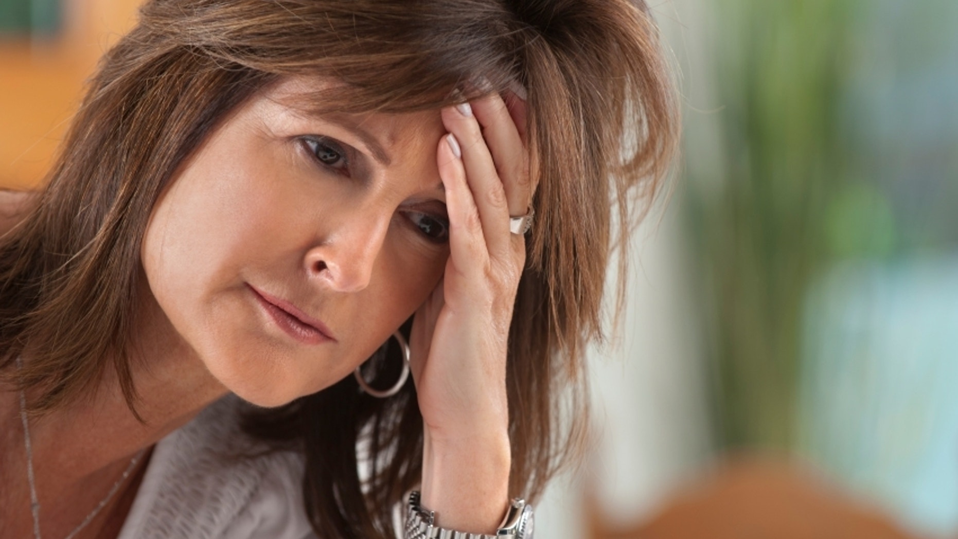 Worried Mature woman holding her head