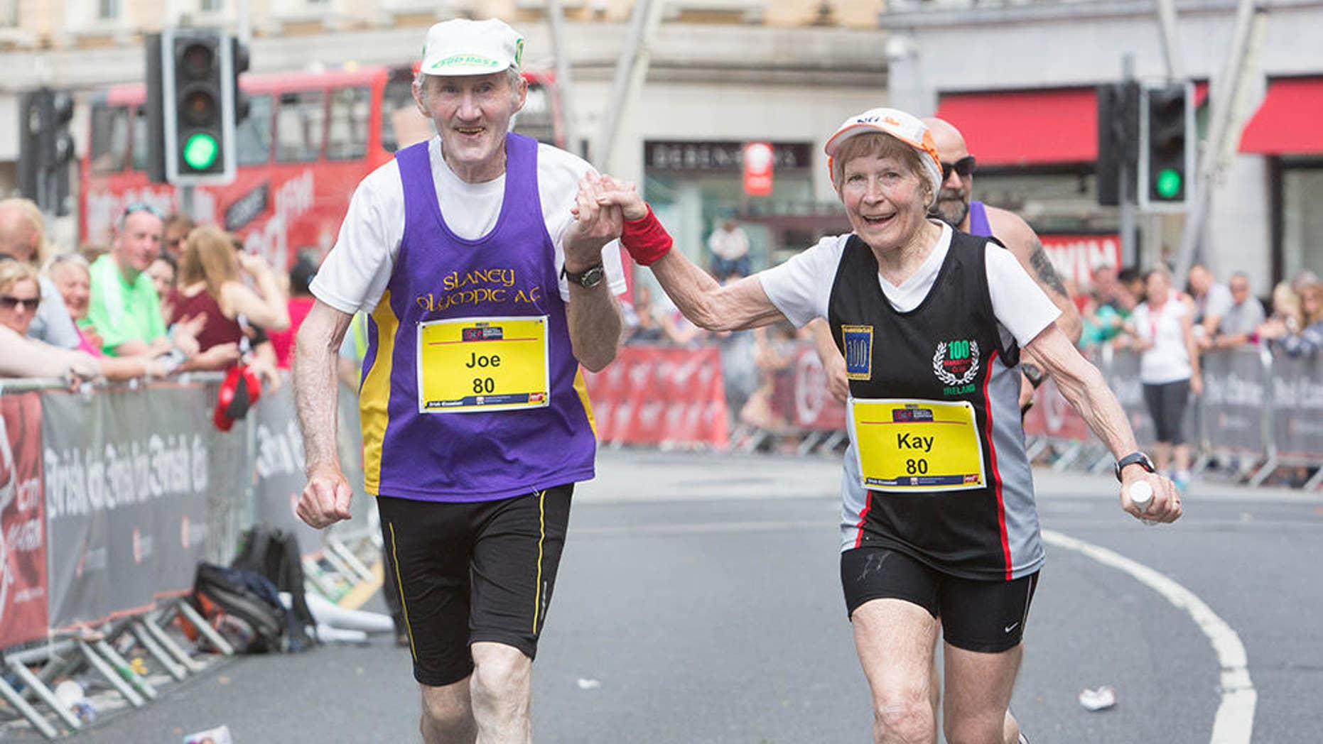 Kay and Joe O'Regan grasp hands as they approach the finish line of the 2016 Cork City Marathon. (photograph courtesy of Cork City Marathon)