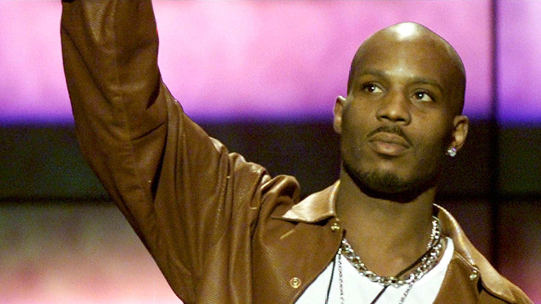 A March 4 2000 file photo shows rapper DMX at the 14th annual Soul Train Music Awards. Rapper DMX was charged June 25, 2004 with cocaine possession and criminal impersonation after trying to steal a car then crashing another vehicle through an airport parking lot gate, claiming he was a federal agent, prosecutors said. DMX, 33, whose real name is Earl Simmons, and a man police identified as Jackie Hudgins, 41, were arrested Thursday night at New York's Kennedy airport by police officers who found a billy club and a bag of crack cocaine in their sport utility vehicle, Queens District Attorney Richard Brown said. REUTERS/Gary Hershorn JDP - RTR56ZZ