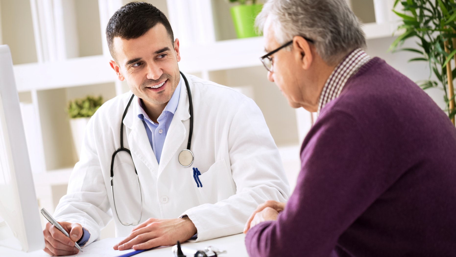 Doctor explaining prescription to senior patient, healthcare concept