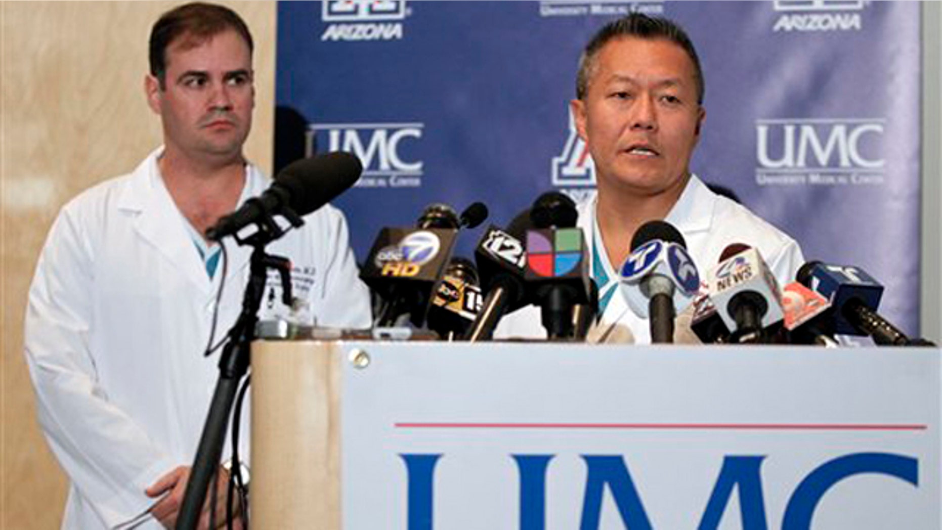 Dr. Peter Rhee, right, speaks about the condition of U.S. Rep. Gabrielle Giffords, D-Ariz., as Dr. G. Michael Lemole, Jr., looks on at University Medical Center during a news conference in Tucson, Ariz., Sunday, Jan. 9, 2011.