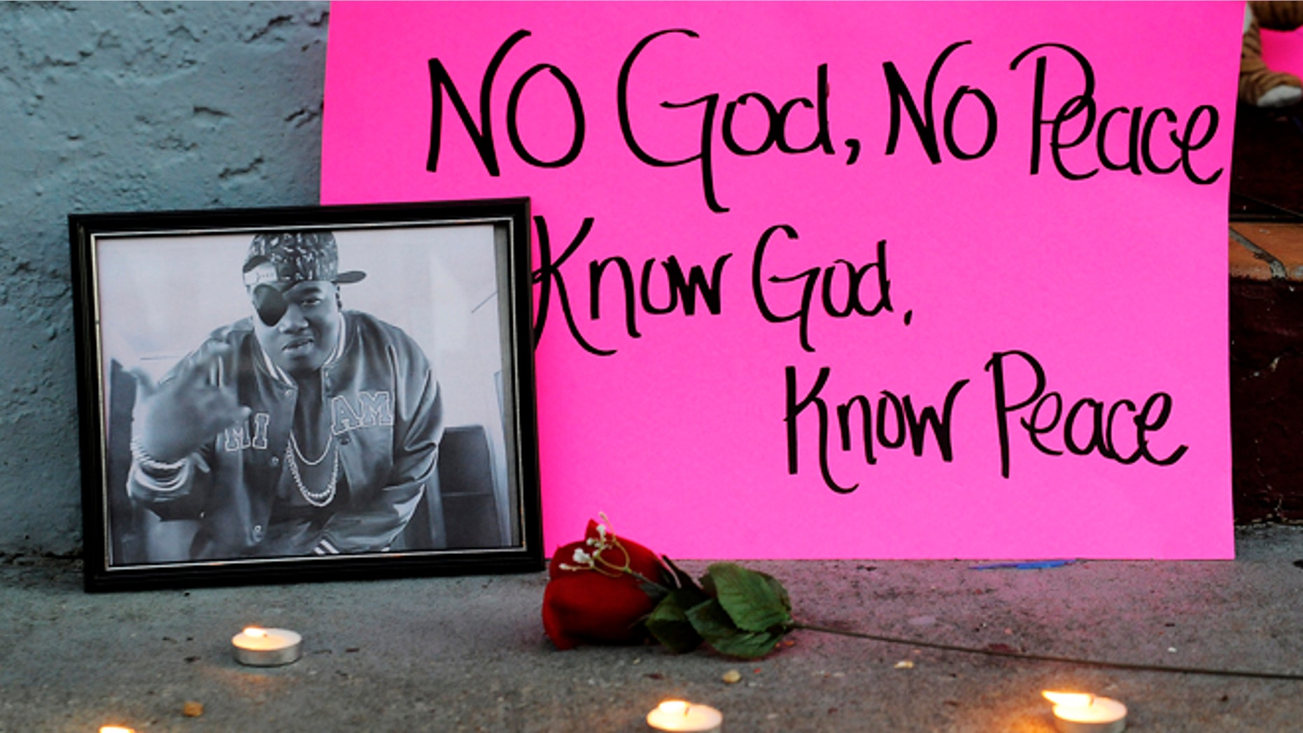 Dec. 29, 2013: A photo of slain rapper Glenn "Doe B." Thomas sits on a sidewalk Sunday, Dec. 29, 2013, at a candlelight vigil for victims of a fatal shooting at Centennial Hill Bar and Grill in Montgomery, Ala.