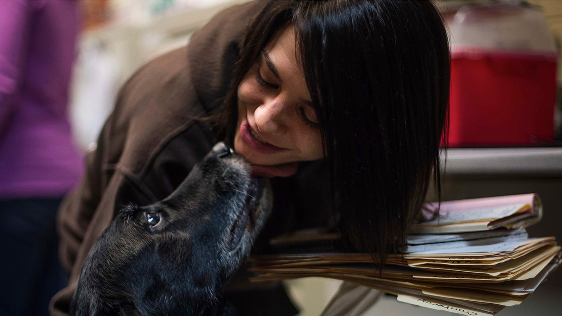 Jody Berisko, an employee at Animal Protectors of Allegheny Valley gets a kiss from Abby on Jan. 30, 2018.