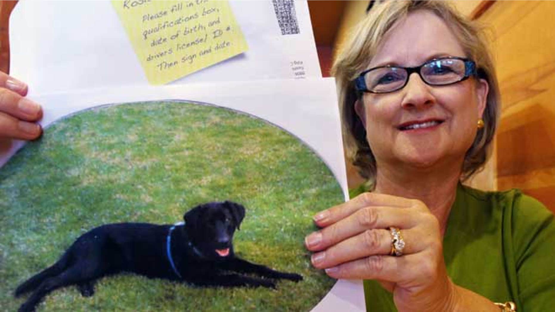 July 11, 2012:In this photo Brenda Charlston holds a photo of her long-deceased dog, Rosie, and a voter registration form for "Rosie Charlston" that arrived in the mail for the canine last month in Seattle.