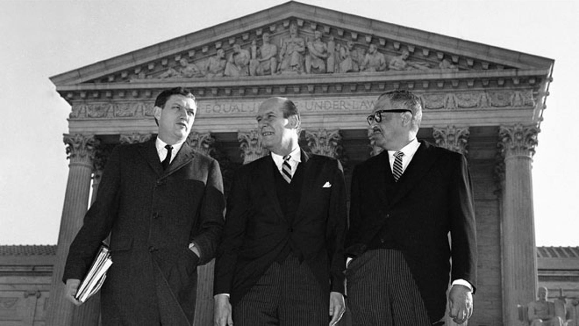 In this Jan. 17, 1966 file photo, Assistant Attorney General John Doar, left, stands with Attorney General Nicholas Katzenbach, center, and Solicitor General Thurgood Marshall as they arrive at the Supreme Court building in Washington to defend the legality of the 1965 Voting Rights Act. (AP)