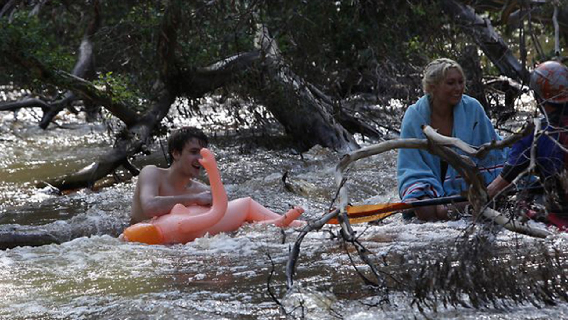 A couple had to be rescued after a ride on an inflatable doll left them stuck in the Yarra River. (Trevor Pinder/Herald Sun)