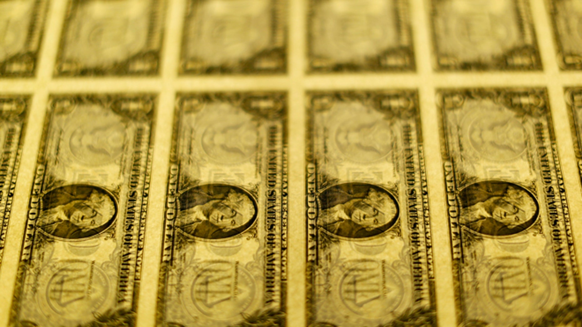 United States one dollar bills are seen on a light table at the Bureau of Engraving and Printing in Washington November 14, 2014. REUTERS/Gary Cameron (UNITED STATES - Tags: BUSINESS POLITICS) - RTR4E70P