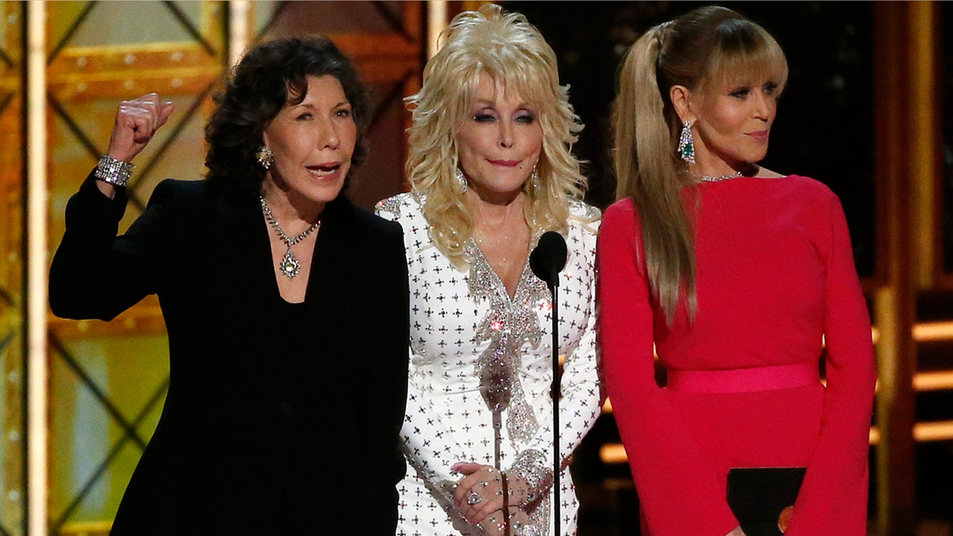 Dolly Parton (center) remained tight lipped when Lily Tomlin (left) and Jane Fonda (right) cracked a Trump joke at the 2017 Emmys.