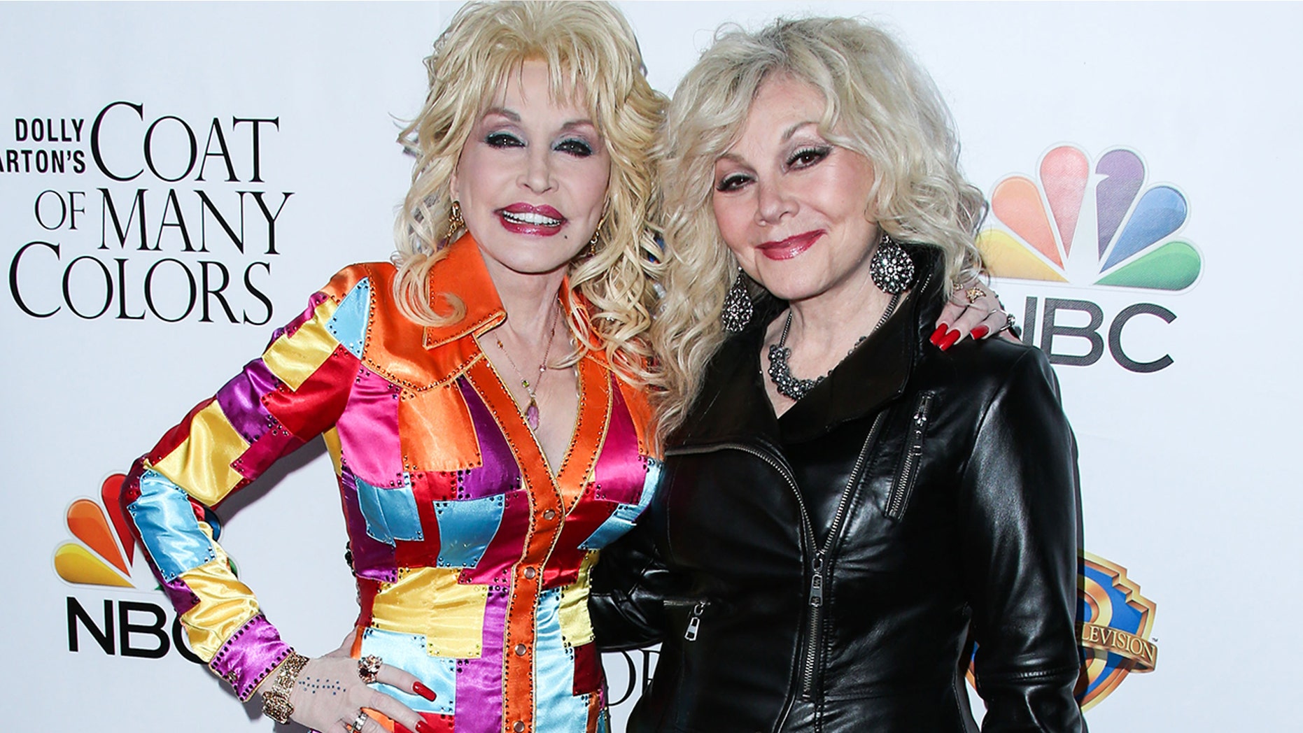 Dolly Parton (left) and Stella Parton attend the Los Angeles Premiere Of Warner Bros. Television's "Dolly Parton's Coat Of Many Colors" held at the Egyptian Theatre on December 2, 2015.