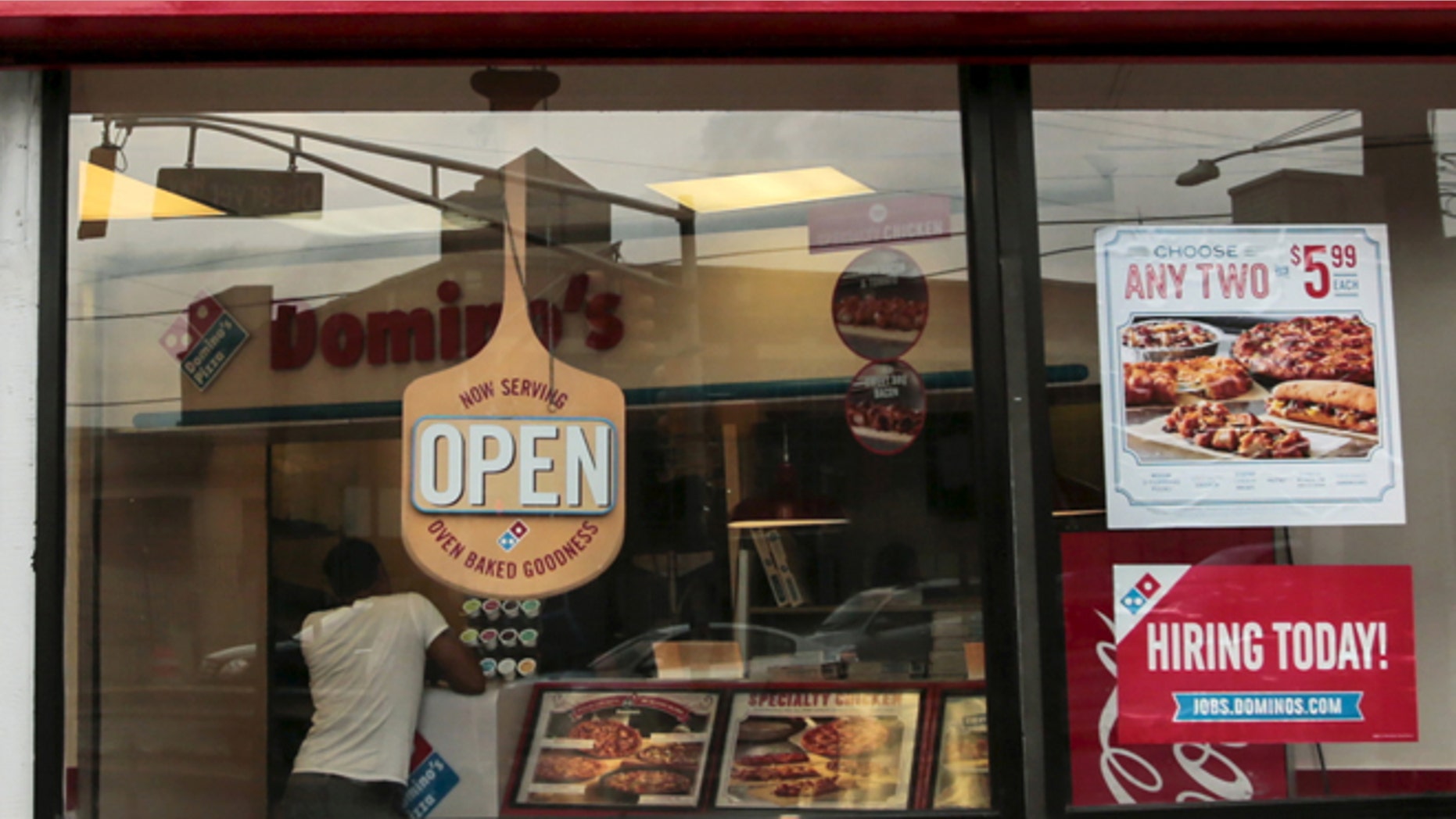 July 8, 2015: A man buys food at Domino's restaurant in Hoboken, N.J.
