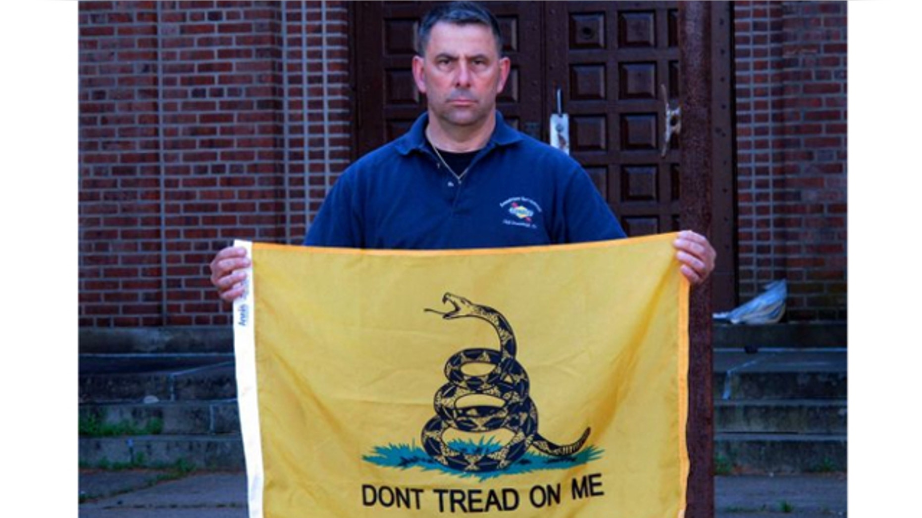 April 26, 2013: Peter Parente, president of the United Veterans Memorial and Patriotic Association, holds a Gadsden flag outside an armory in New Rochelle, N.Y.