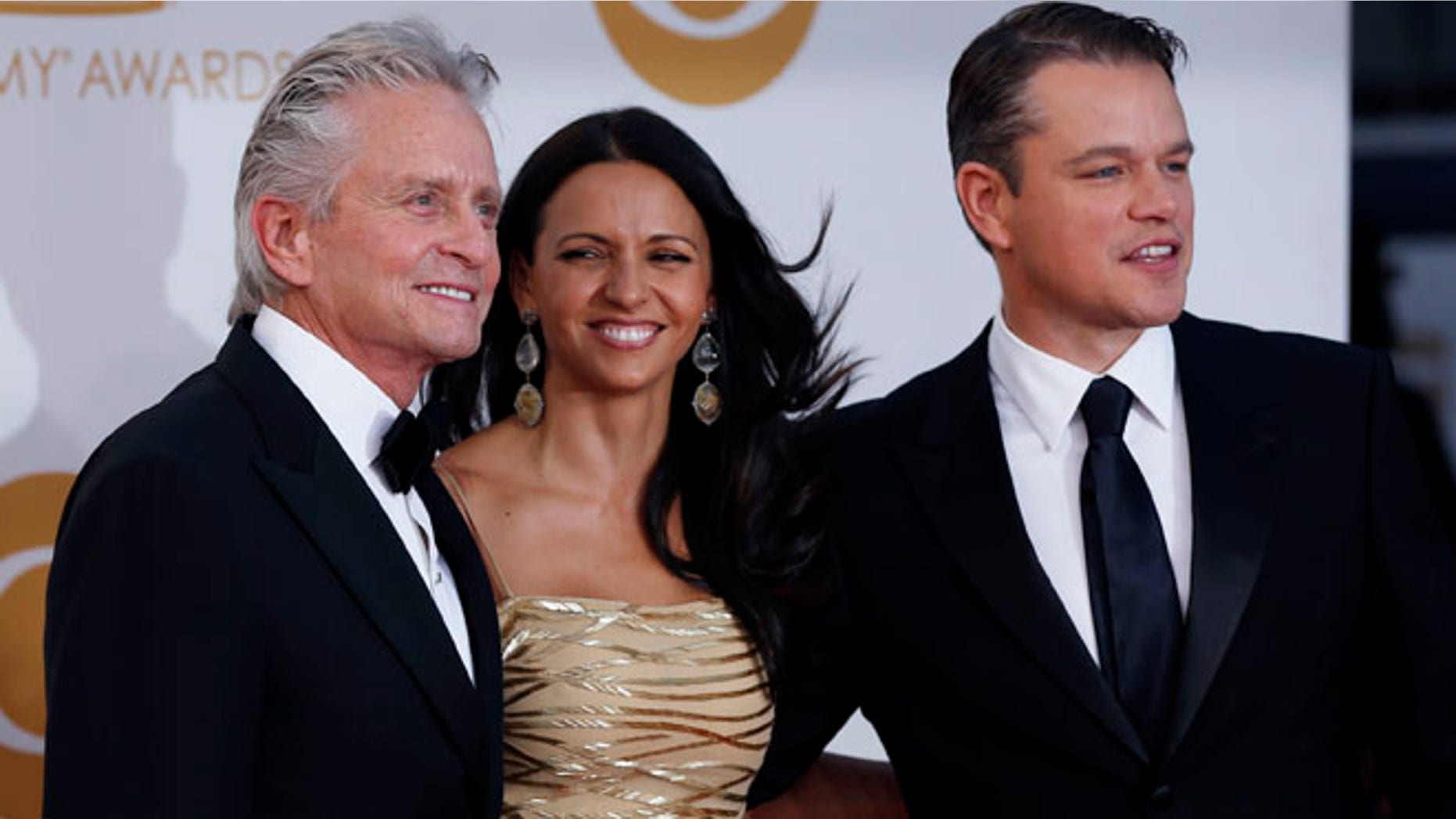 Actor Michael Douglas from HBO's movie "Behind the Candelabra" arrives with co-star Matt Damon and his wife, Luciana Barroso, at the 65th Primetime Emmy Awards in Los Angeles September 22, 2013. REUTERS/Mario Anzuoni (UNITED STATES Tags: ENTERTAINMENT) (EMMYS-ARRIVALS) - RTX13VT2