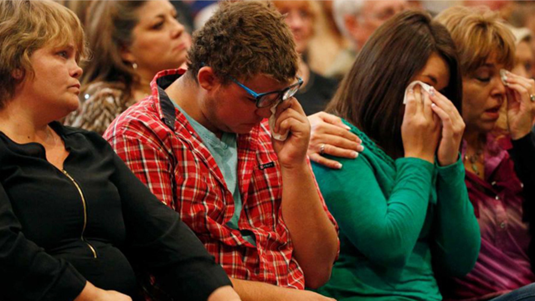 From left, Summer Smith, Mathew Downing, Lacey Scroggins and Lisa Scroggins attend a Roseburg, Ore., church service, Sunday, Oct. 4, 2015. Downing and Lacey Scroggins are survivors of the shooting at Umpqua Community College.(AP)