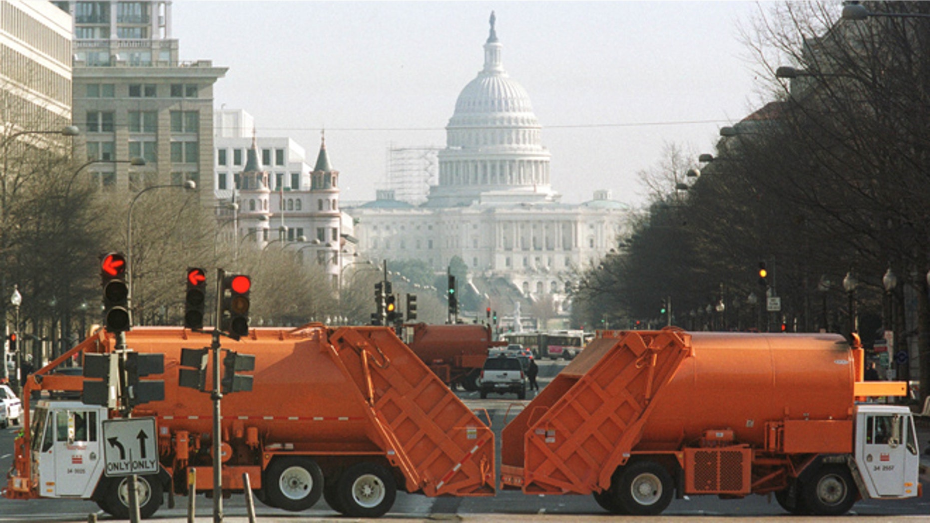 FILE: Washington, D.C. municipal garbage trucks are seen on Pennsylvania Avenue.
