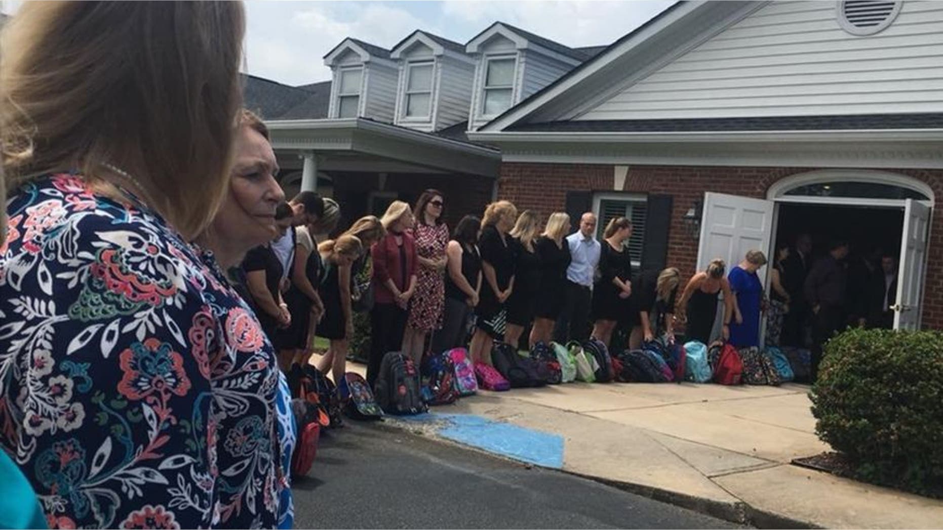 Honorary pallbearers pay tribute to school teacher Tammy Waddell.