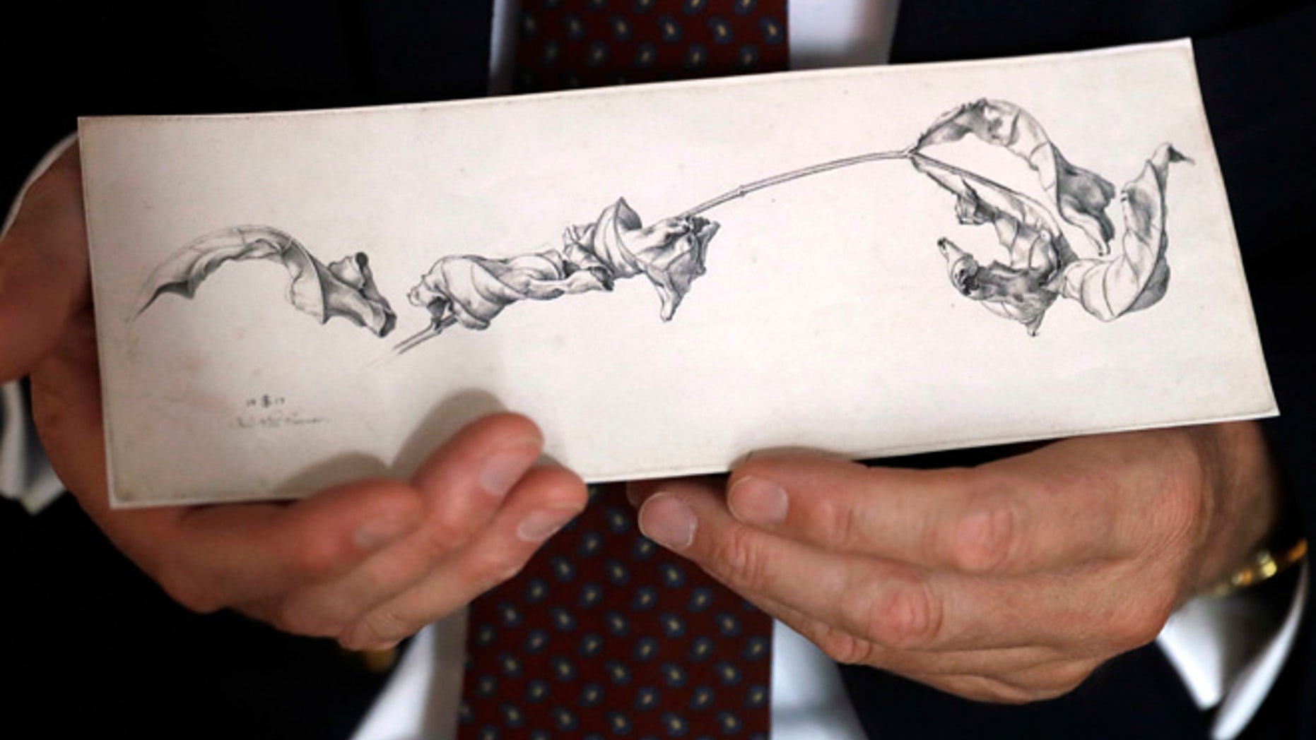 Dr. Johann Schiller holds a replica of a nearly 200-year-old drawing, Wednesday, Aug. 17, 2016, in Washington, after the original was returned to his family from the National Gallery of Art's collection decades after his relative was forced to sell it during World War II because of her Jewish heritage. (AP Photo/Jacquelyn Martin)