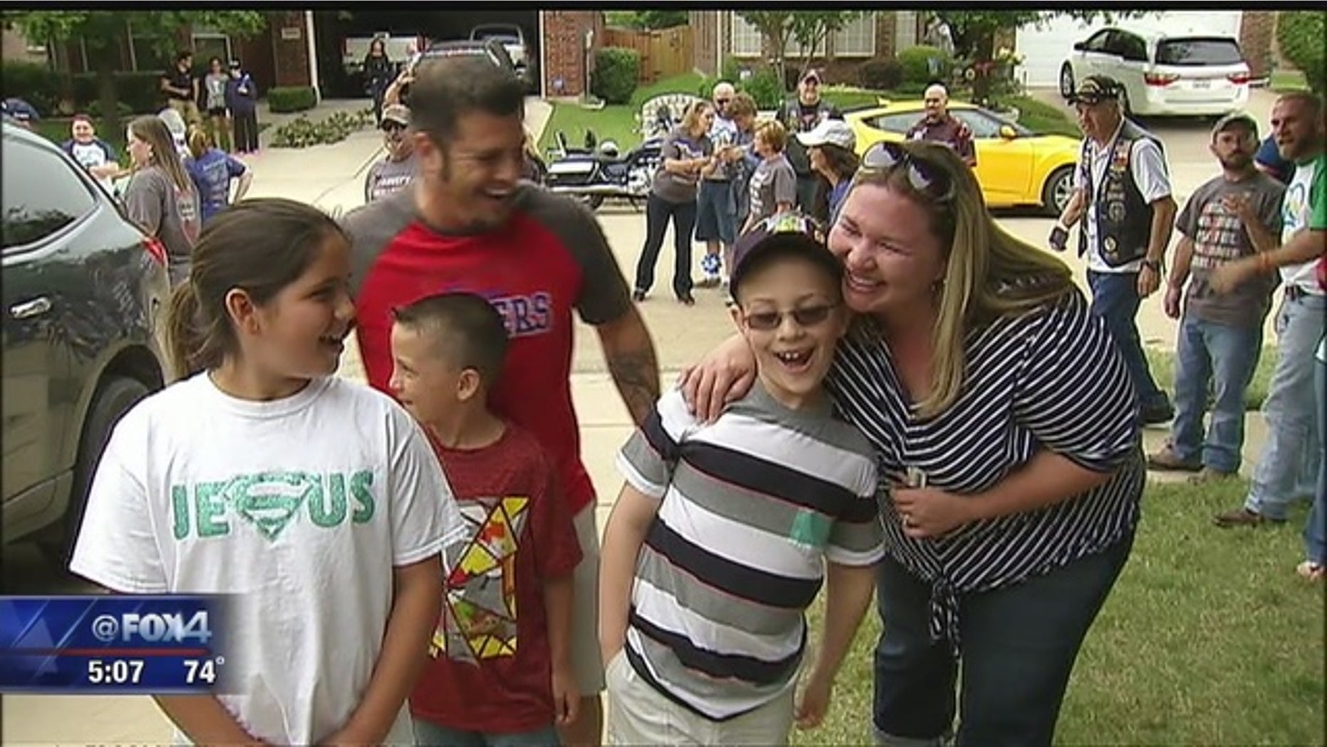 Bryce Aswell, center, arrives at his home to see his new room with his family.
