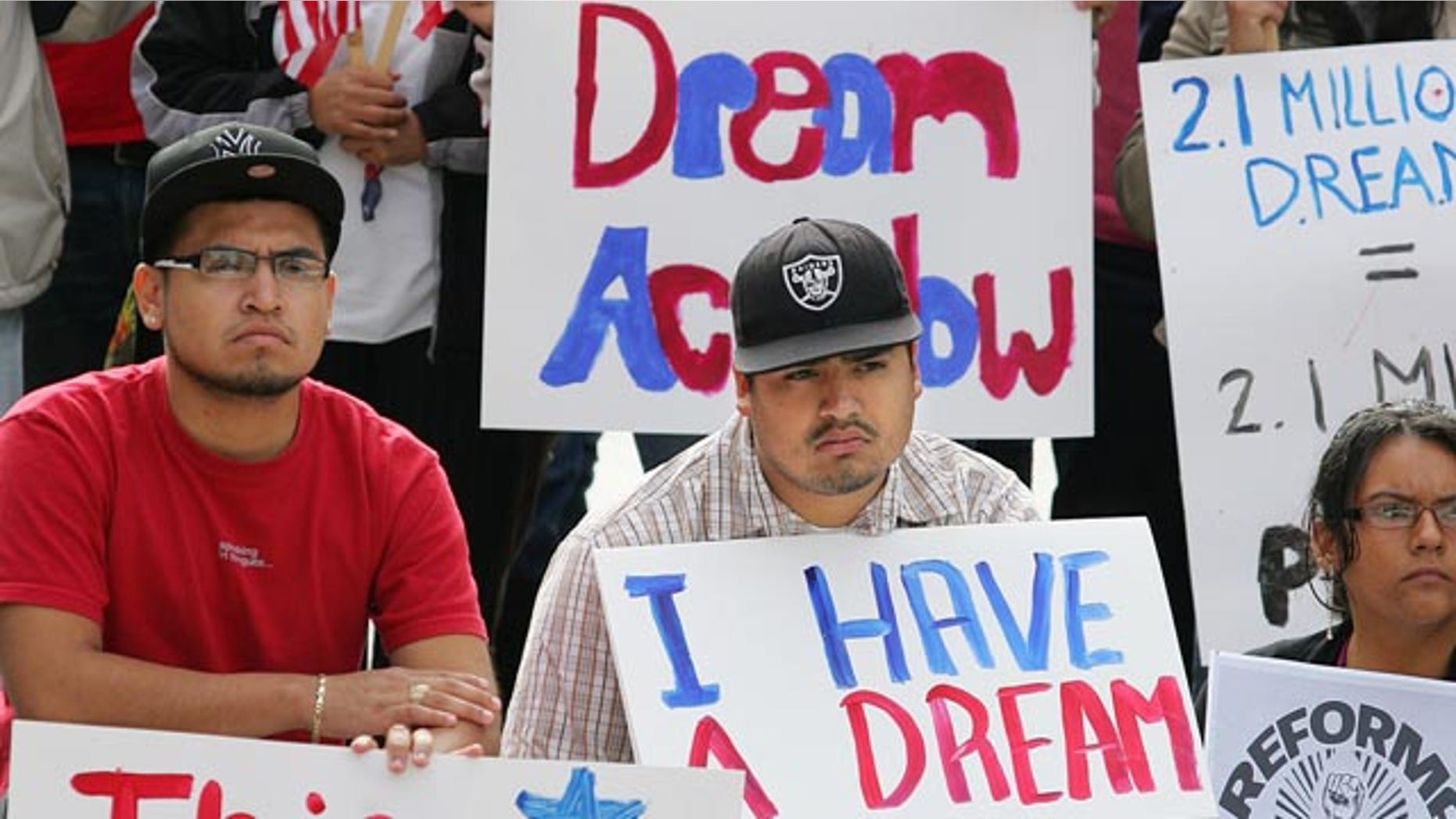 Miguel Campos, left and Eduardo Rodriguez hold signs in support of Fresno State Student Body President Pedro Ramirez who spoke to hundreds of students and faculty about getting the Dream Act passed by Congress Friday, Nov. 19, 2010 in Fresno, Calif. in the Free Speech area of the university. Ramirez was recently outted as being undocumented and could now face deportation. The legislation would grant undocumented students who were brought into the United States as minors by their parents a path to citizenship through higher education or military service. (AP Photo/Gary Kazanjian)