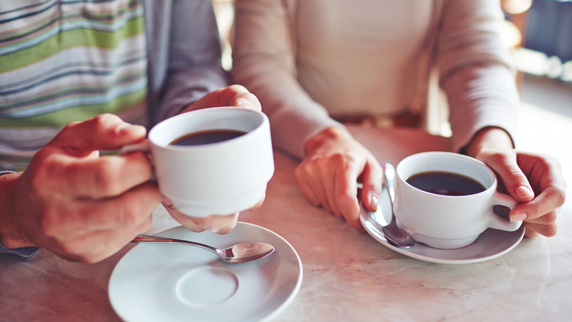 Close-up of couple drinking coffee