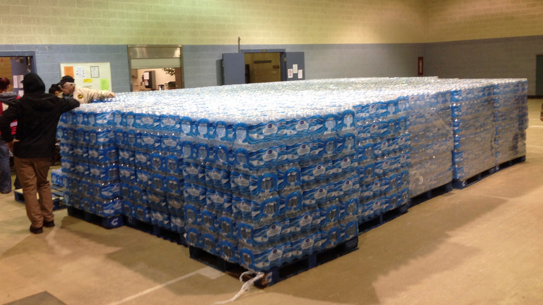 Pallets of water, ready for distribution in the community, sit at the Sebring Community Center, Tuesday, Jan. 26, 2016 in Sebring, Ohio. Authorities have been handing out bottled water, and schools were closed Tuesday for a third day in Sebring, a village about 60 miles southeast of Cleveland. The Sebring water system serves 8,100 homes and businesses in three Mahoning County communities. Testing over the weekend in Sebring found one school drinking fountain with lead levels that exceed EPA standards. (AP Photo/Mark Gillispie)