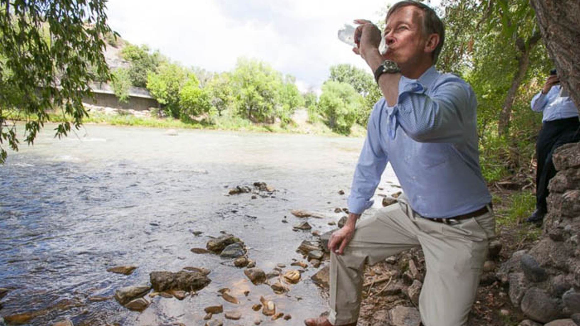 Colorado Gov. John Hickenlooper drank water straight from the contaminated river to prove a point, but critics said he proved he's crazy. (AP via Durango Herald)