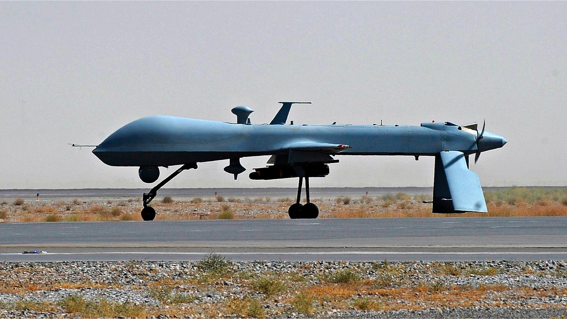June 13, 2010: U.S. Predator unmanned drone armed with a missile stands on the tarmac of Kandahar military airport in Afghanistan.