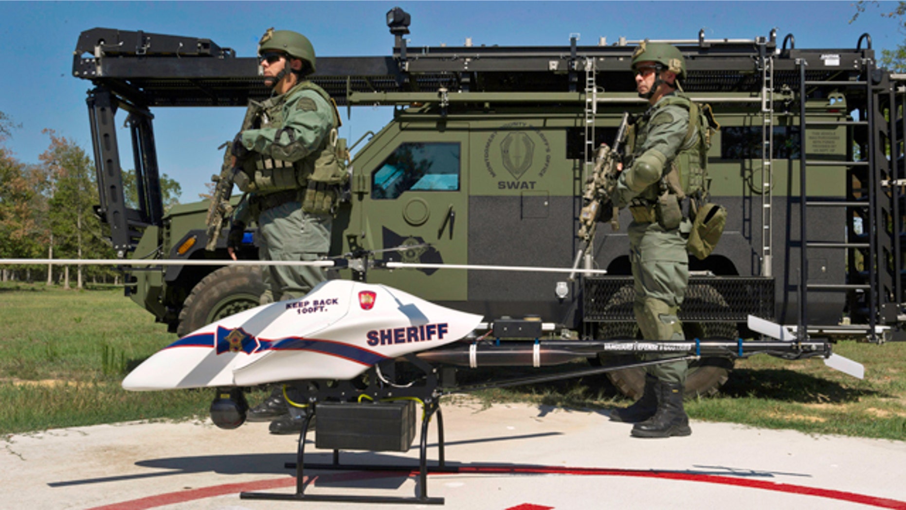 This Sept. 2011 photo provided by Vanguard Defense Industries, shows a ShadowHawk drone with Montgomery County, Texas, SWAT team members.