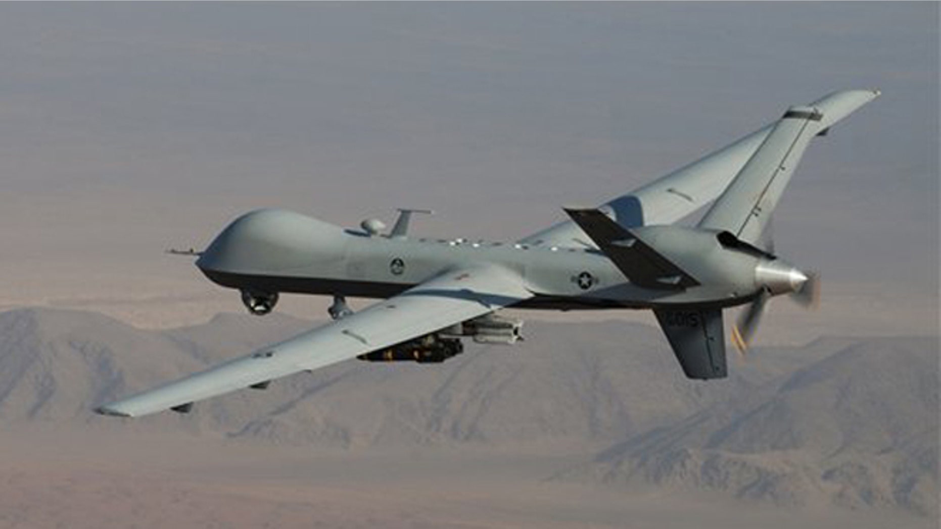 A MQ-9 Reaper, armed with GBU-12 Paveway II laser guided munitions and AGM-114 Hellfire missiles, is piloted by Col. Lex Turner during a combat mission over southern Afghanistan.