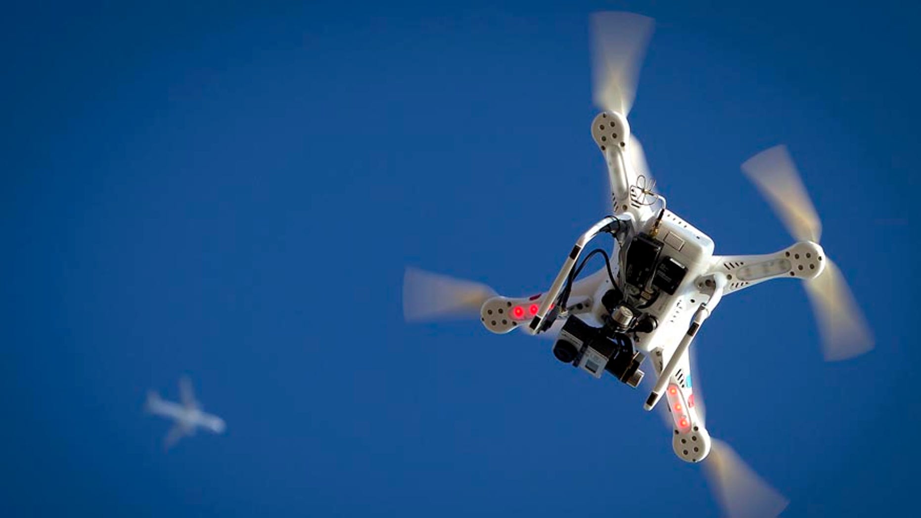 File photo. An airplane flies over a drone during the Polar Bear Plunge on Coney Island in the Brooklyn borough of New York January 1, 2015.