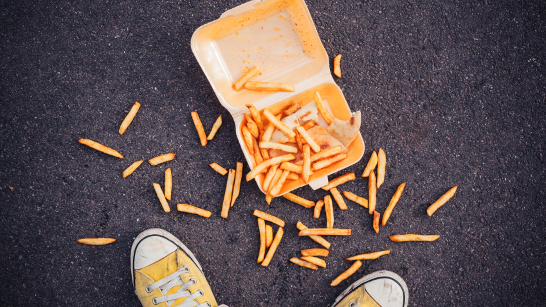 Young man has dropped his chips in the street