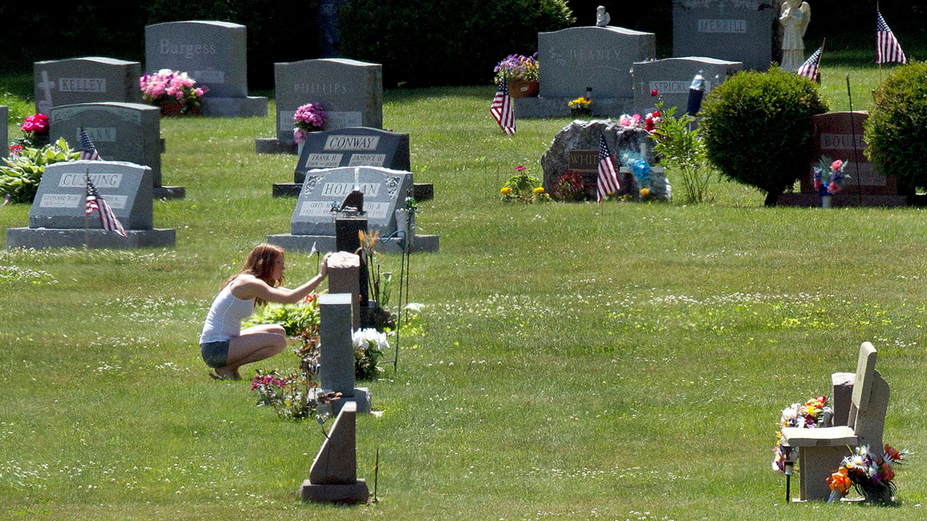 FILE - In this June 17, 2016 file photo, Erika Marble visits the gravesite of Edward Martin III, her fiancé and father of her two children, in Littleton, N.H.