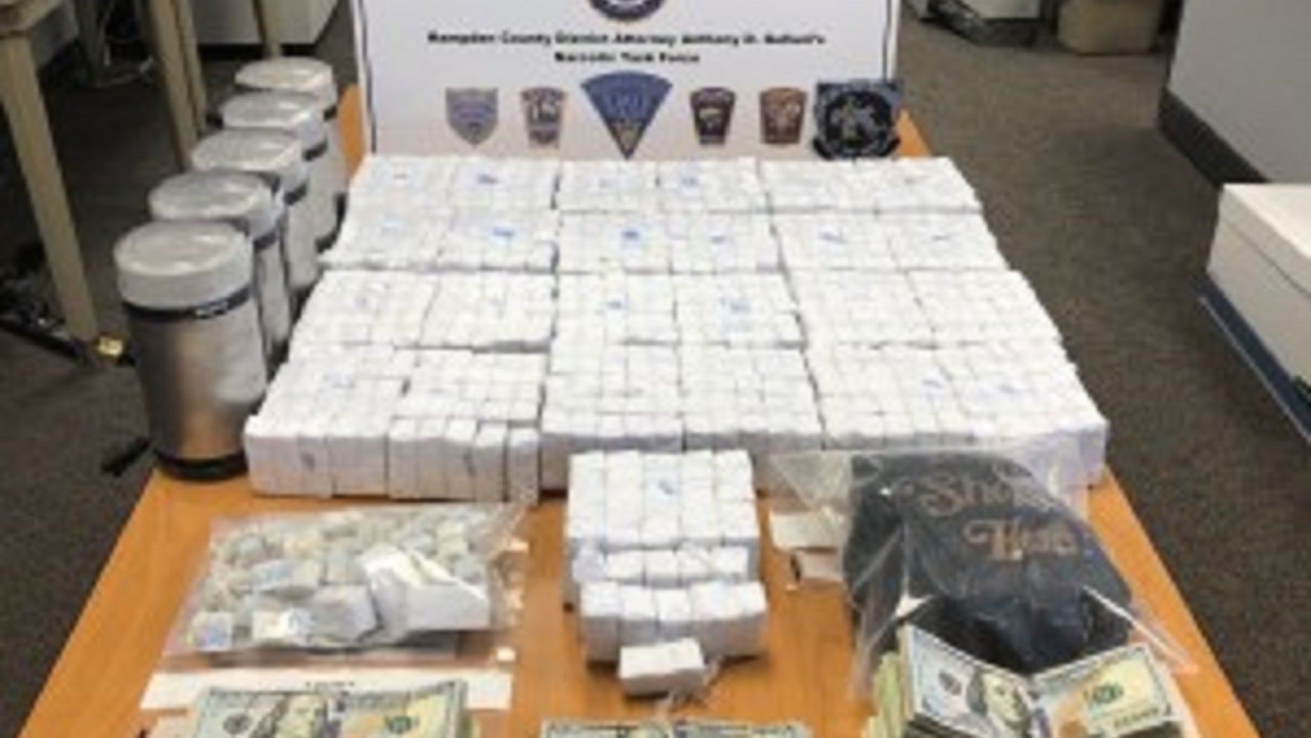 Over $250,000 and approximately 50,000 bags of heroin were seized in a series of raids conducted this week by Massachusetts State Police.