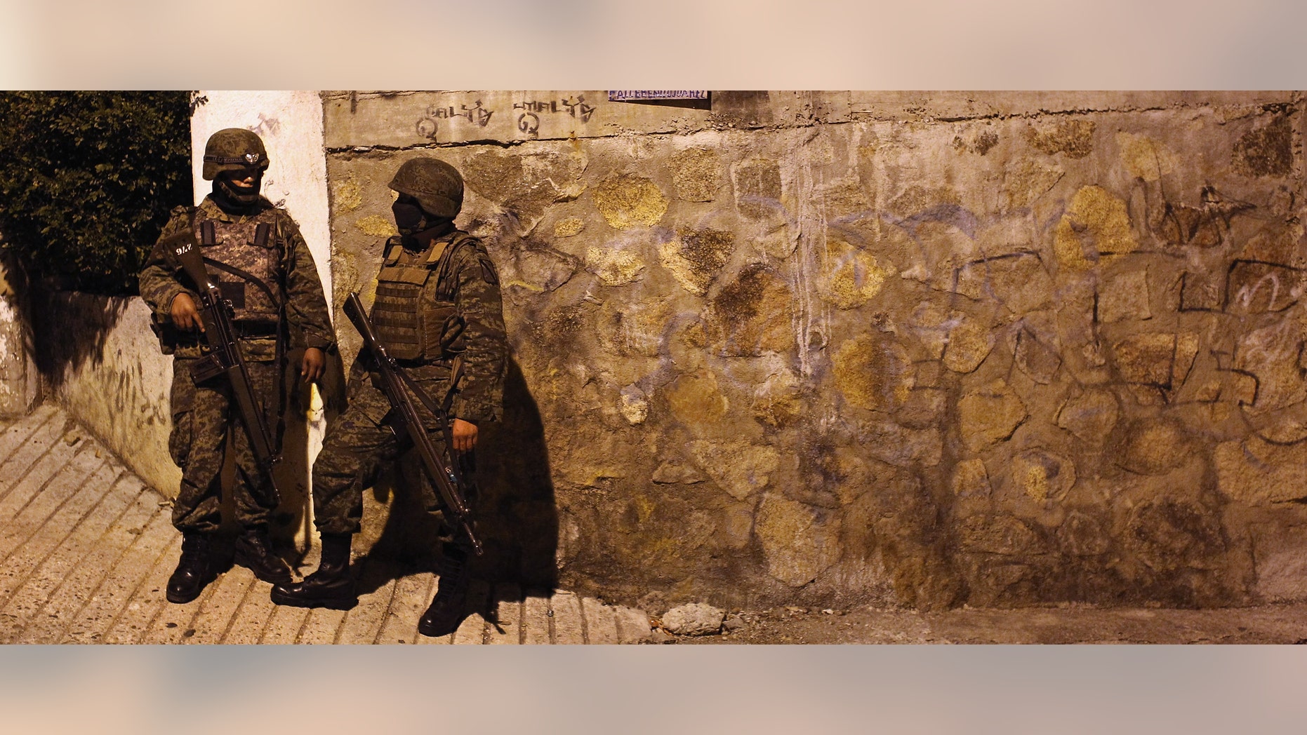 Mexican army soldiers stand guard near a suspected drug-related murder site March 3, 2012 in Acapulco, Mexico.(Photo by John Moore/Getty Images)