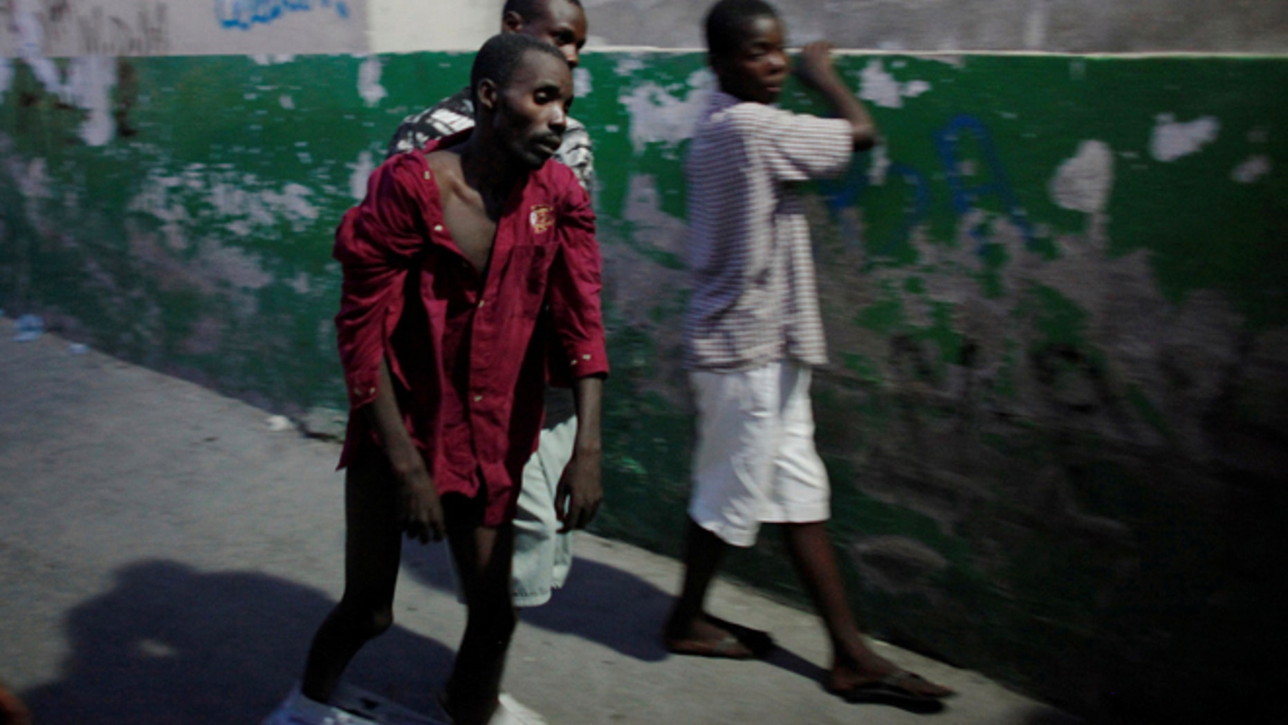 FILE 2010: A Haitian with cholera arrives to receive treatment at St-Catherine hospital in the slum of Cite-Soleil in Port-au-Prince