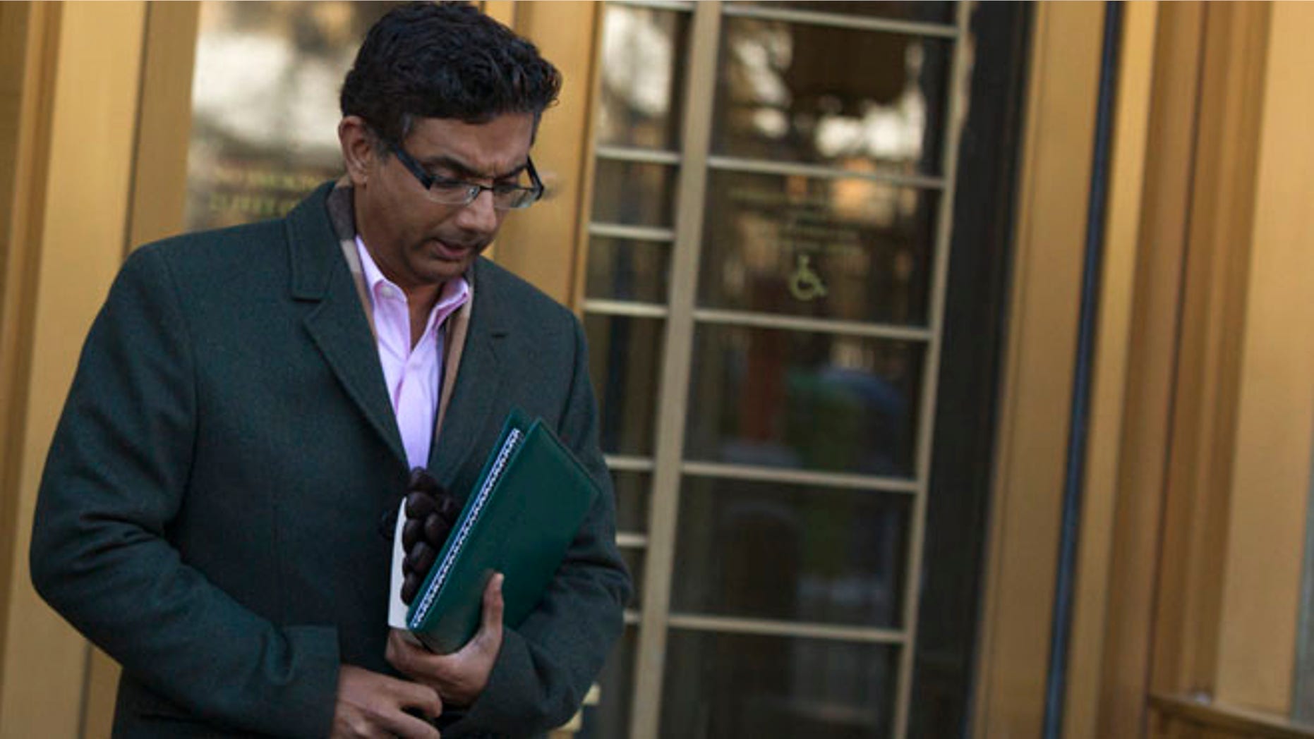 Jan. 24, 2014: Conservative commentator and best-selling author, Dinesh D'Souza exits the Manhattan Federal Courthouse in New York.