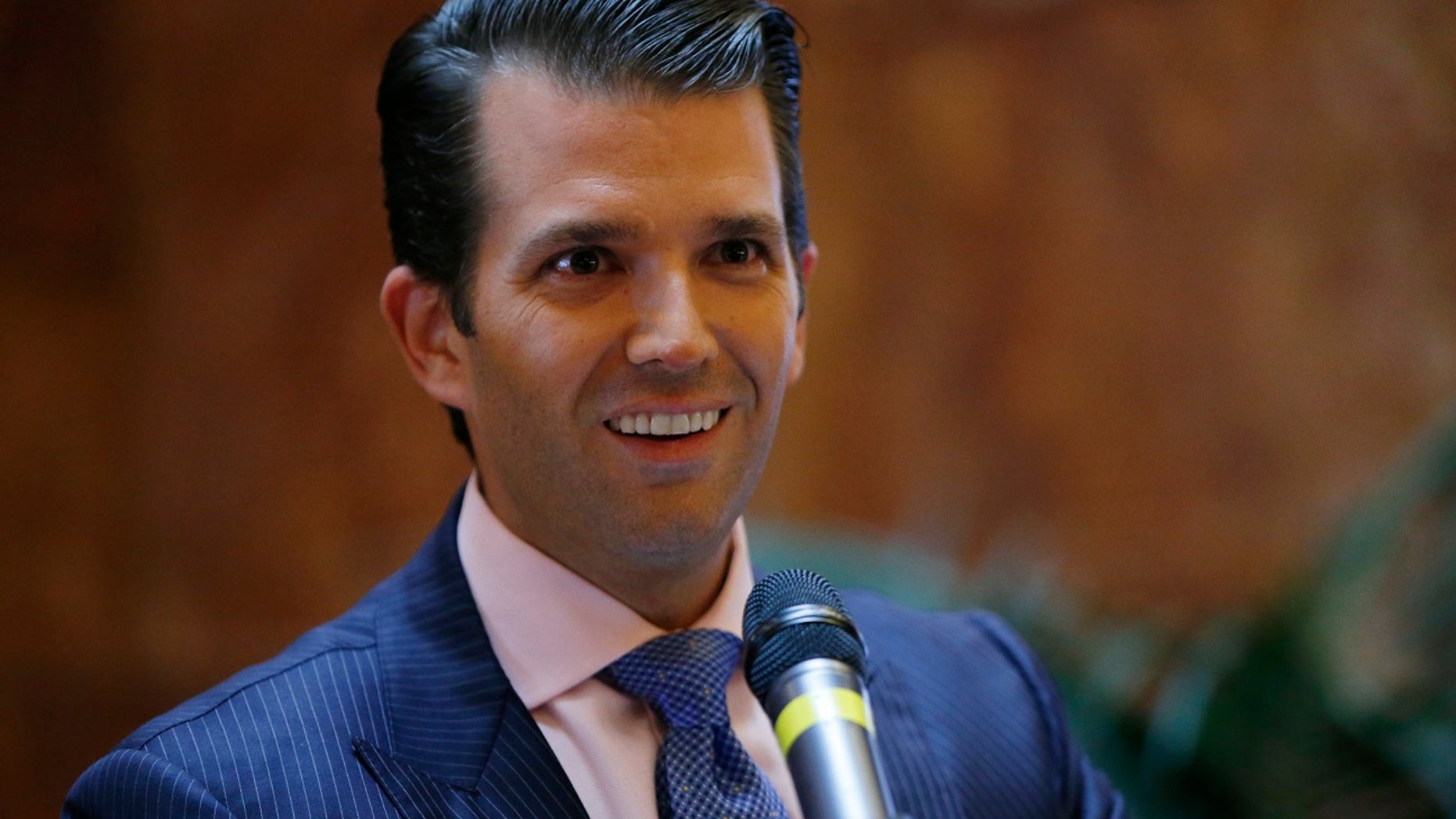 FILE - In this June 5, 2017, file photo, Donald Trump Jr., executive vice president of The Trump Organization, announces that the family's company is launching a new hotel chain inspired by his and brother Eric's Trump's travels with their father's campaign at Trump Tower in New York. Trump Jr. shared a video on July 8, 2017, of an edited clip of the 1986 military thriller âTop Gunâ in which President Donald Trumpâs face is superimposed over Tom Cruiseâs character as he shoots down a Russian jet with a CNN logo on it. (AP Photo/Kathy Willens, File)