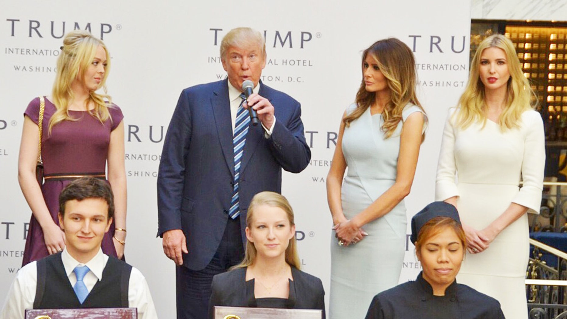 Flanked by the women in his family, Donald J. Trump greeted invited guests to the official opening of his Washington hotel Wednesday.