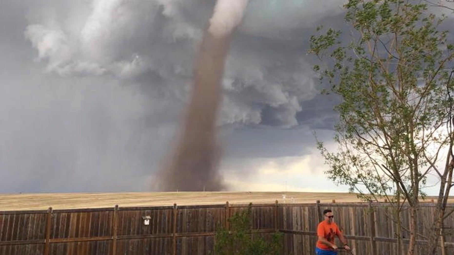 A Canadian man continued to mow his lawn in Three Hills, Alberta, while a massive tornado swirled in the area behind him on Friday, June, 2, 2017.