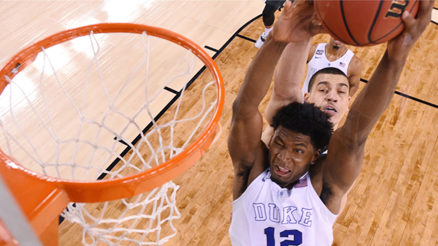 Apr. 4, 2015: Duke's Justise Winslow (12) is fouled by Michigan State's Gavin Schilling, rear, during the second half of the NCAA Final Four tournament college basketball semifinal game. (AP)