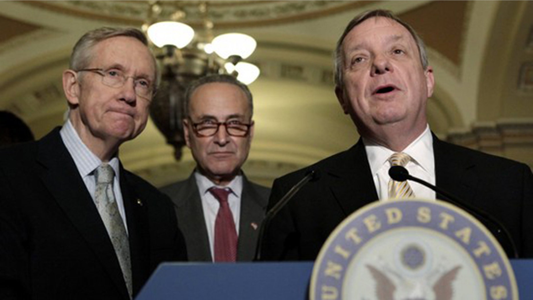 Sen. Dick Durbin, right, speaks to the media, alongside Senate Majority Leader Harry Reid, left, and Sen. Charles Schumer on Capitol Hill in Washington June 23.