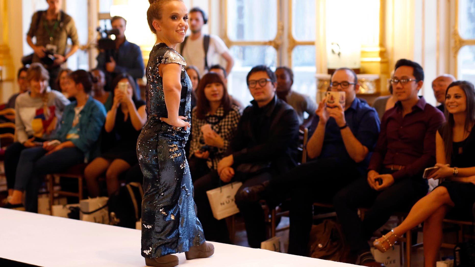 October 2, 2015. A model hits the catwalk at the French Ministry of Culture during the dwarf fashion show in Paris, France.