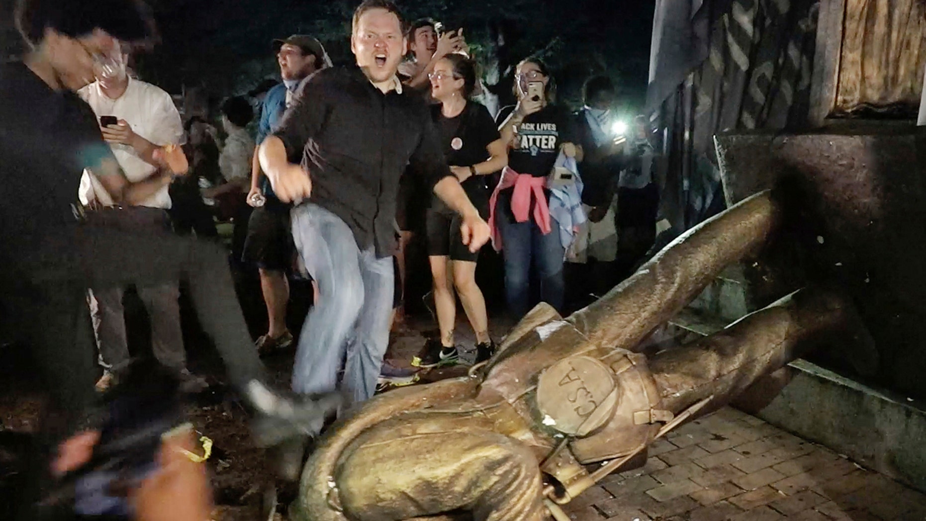 Aug. 20: Protesters celebrate after the Confederate statue known as "Silent Sam" was toppled on the campus of the University of North Carolina in Chapel Hill.