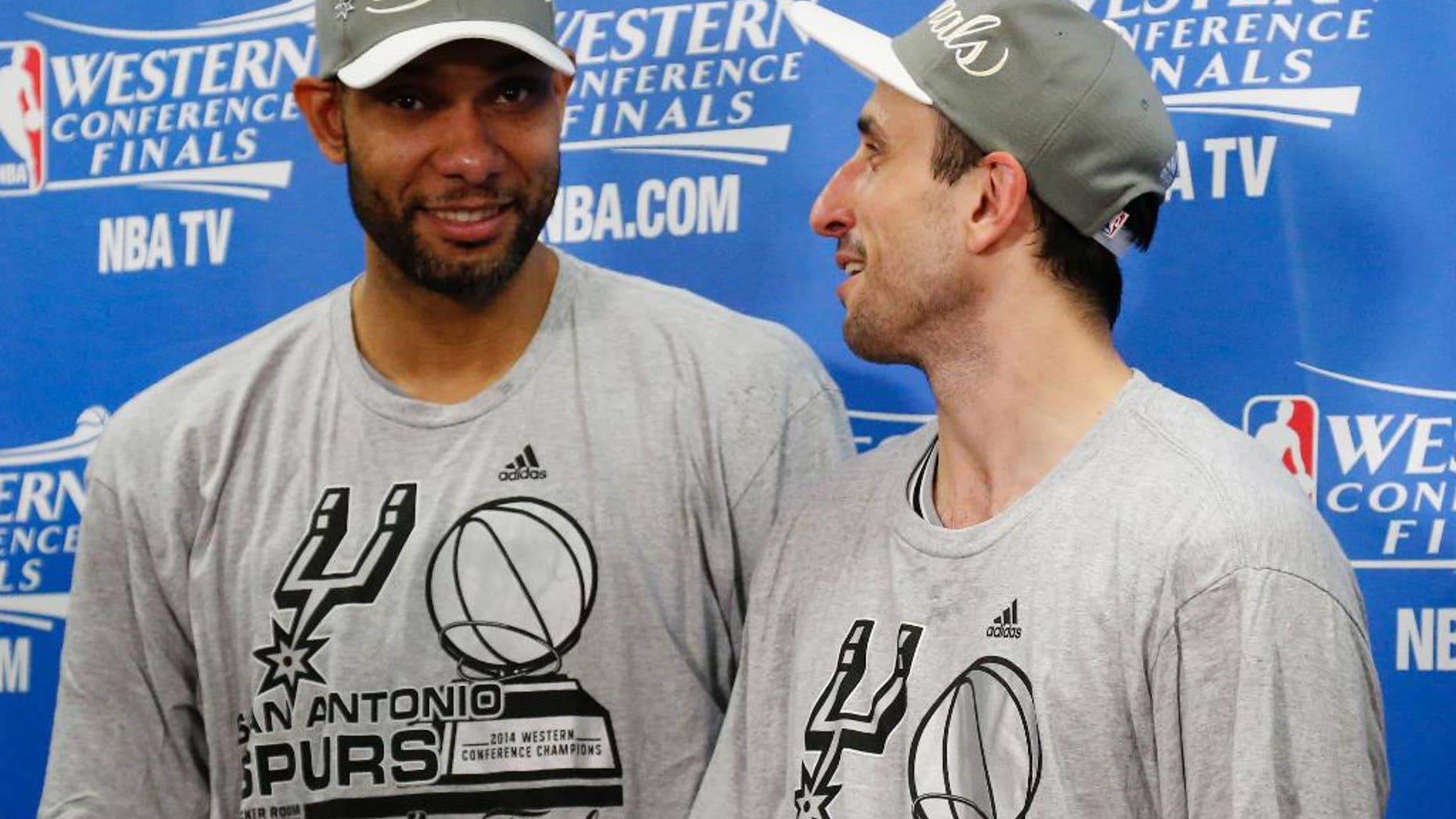 San Antonio Spurs' Tim Duncan, left and Manu Ginobili talk following Game 6 of the Western Conference finals NBA basketball playoff series against the Oklahoma City Thunder in Oklahoma City, Saturday, May 31, 2014. San Antonio won 112-107, and advanced to the NBA Finals. (AP Photo/Sue Ogrocki, Pool)